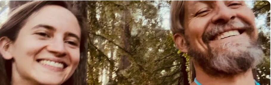 Joey Lundgreen and Lydia laughing together under the trees